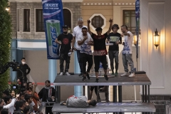 NPDL20JUL2822. An Iranian athlete reacts as he won after compete in a Parkour Speed Run competition as looser lies on a race track, in a shopping mall which is currently under constructions in northwestern Tehran on July 28, 2022.
