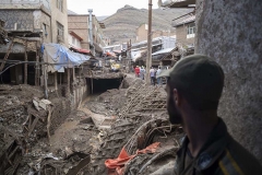 NPNW09JUL2922. An Iranian policeman looks at an area which is demolished in flash flooding in the flooded village of Imamzadeh Davood in the northwestern part of Tehran on July 29, 2022.