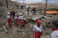 NPNW16JUL3122. Members of the Iranian Red Crescent Society (IRCC) works on the ruins of a destroyed house caused of flash flooding as they search for bodies of flood victims in the flooded village of Mazdaran in Firoozkooh county 124 km (77 miles) northeast of Tehran, after flash flooding, July 31, 2022.