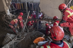NPNW18JUL2922. Iranian firefighters works at a destroyed shop caused of flash flooding as they search for bodies of flood victims in the flooded village of Imamzadeh Davood in the northwestern part of Tehran on July 29, 2022.