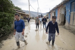 NPNW24AUG0122. Iranian villagers walk along a street covered in floodwater shortly after a sudden heavy rain in the flooded village of Mazdaran in Firoozkooh county 124 km (77 miles) northeast of Tehran, August 1, 2022.
