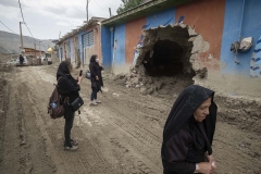 NPNW25AUG0322. An Iranian woman shoot video with her smartphone of a mud-covered destroyed building five days after a sudden flooding in the flooded village of Mazdaran in Firoozkooh county 124 km (77 miles) northeast of Tehran, August 3, 2022.