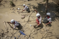 NPNW30AUG0222. Members of the Iranian Red Crescent Society (IRCC) search for the body of a flood victim at a garden which is filled in floodwaters in the flooded village of Mazdaran in Firoozkooh county 124 km (77 miles) northeast of Tehran, four days after flash flooding, August 2, 2022.
