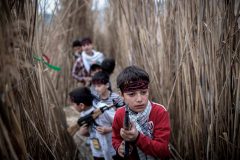 An Iranian schoolboy holds a plastic AK-47 rifle as he take part a war game to commemorate the memory of Iran-Iraq war (1980-88) in Shalamcheh area near the border with Iraq about 980Km south of Tehran, March 24, 2014.